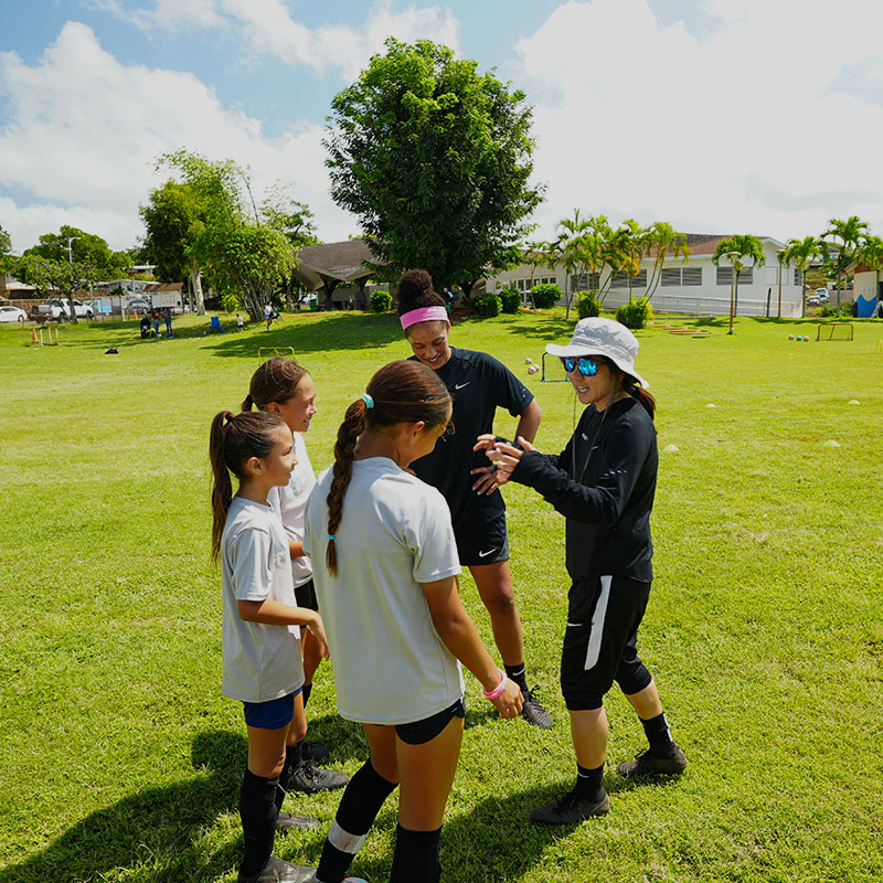 image of Erin Otagaki, Parrissa Eyorokon, and students of Rise Soccer Training Academy