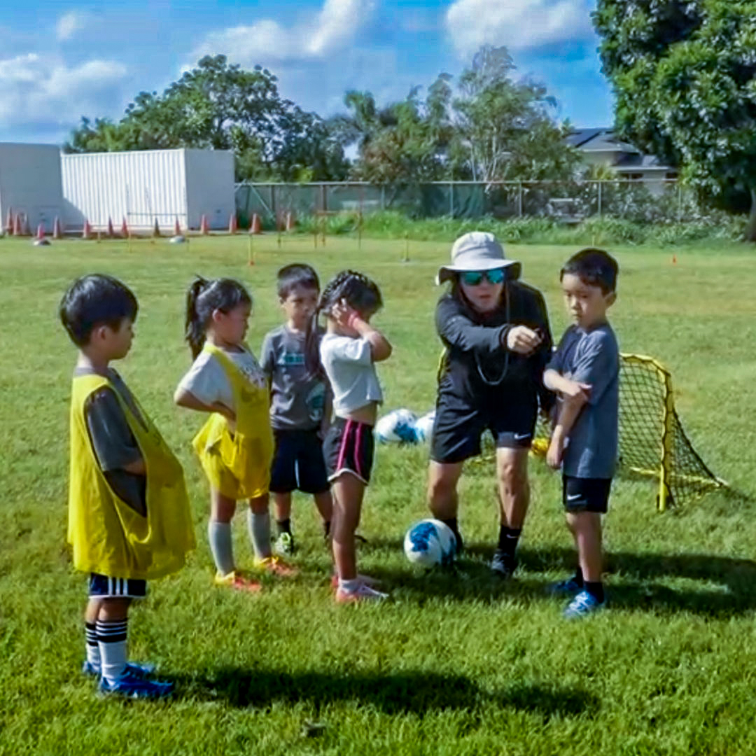 image of coach Erin working with younger students.