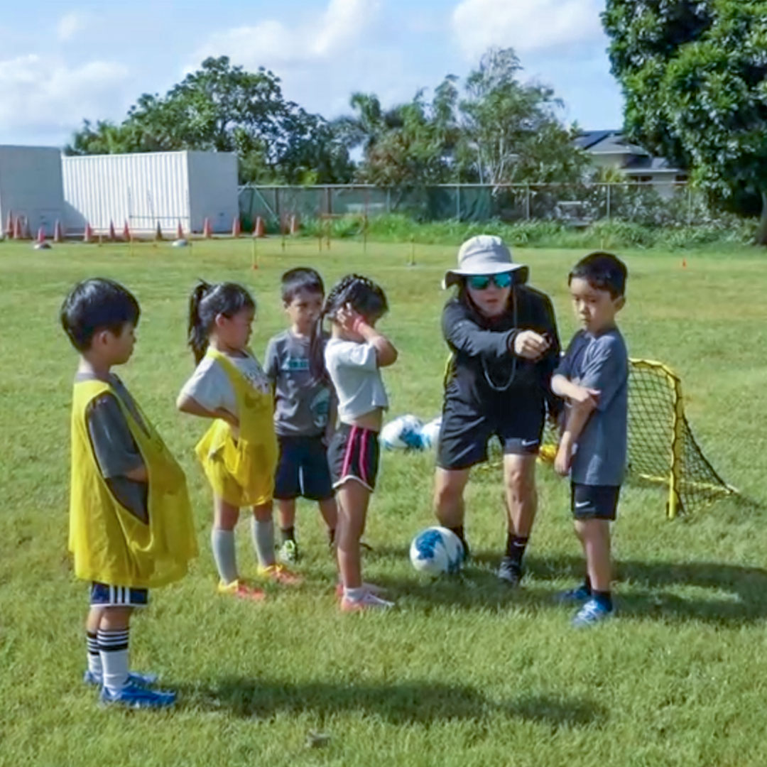 image of coach Erin working with younger students.